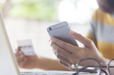 Online payment, Business women's hands holding a smartphone and credit card for online shopping.