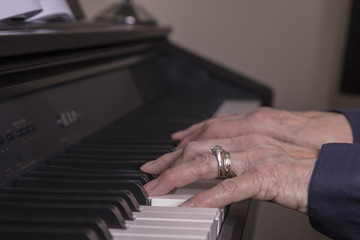 Mature Hands/ An image of a mature lady's hands playing the piano.