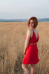 smiling beautiful brunette in the lavender field at sunset
