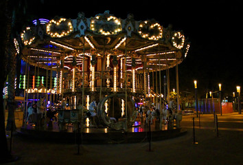 Night view of the illuminated vintage carousel