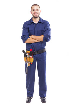 Smiling worker with arms crossed over white background