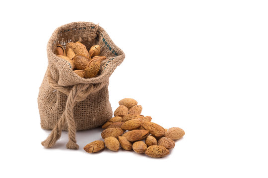 almonds in bag isolated on white background.