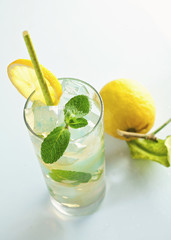 Glass of cold refreshing drink with ice and mint