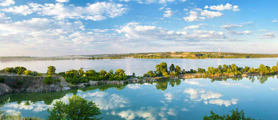 Sky and clouds reflected in water. Beautiful natural landscape. Panoramic view, Ukraine