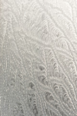 Fototapeta na wymiar A beautiful pattern created by frost on glass