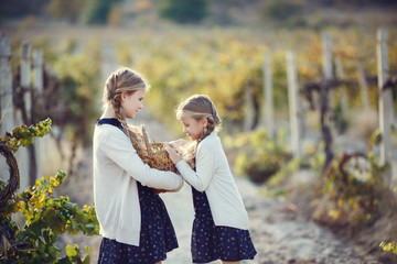 Little girl with grapes outdoors