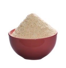 pile whole grain barley flour in bowl isolated on white background