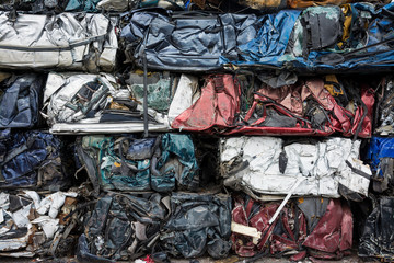 Cars in junkyard,  pressed and packed for recycling.