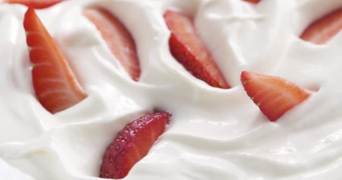 fresh sliced straberries in cream rotating background loopable, 4k prores footage