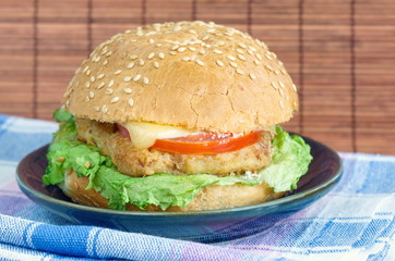 Hamburger with meat, cheese and vegetables