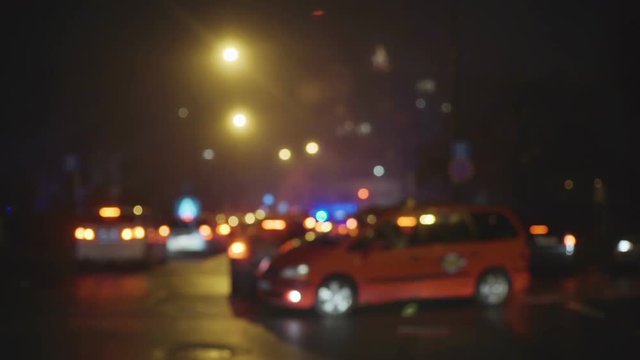 Road traffic in city at night. Shot is made with defocus.