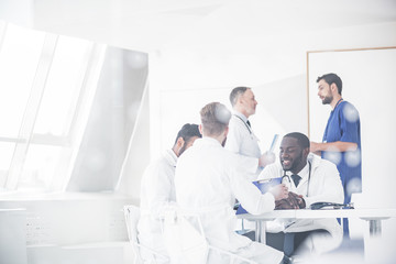 Outgoing physicians deliberating at conference