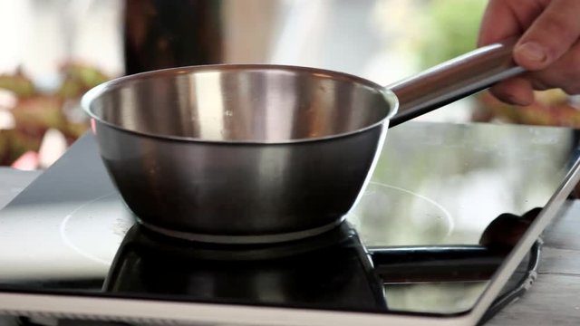 Saucepan on stove. Stainless steel pot.