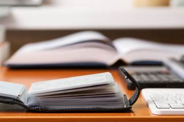 Office desk table with computer, calculator, supplies. Copy space for text