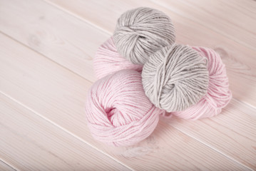 balls of wool pink and gray thread