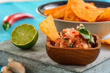 Nachos with salsa and ingredients of salsa