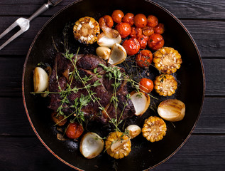 Delicious Grilled Steak sliced on a cutting board served with Gr