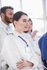 Cheerful medical adviser watching lecture in clinic