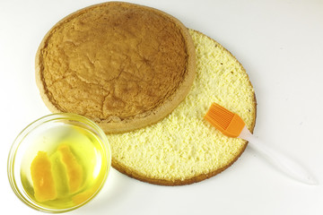 bowl of water and oranges with sponge cake