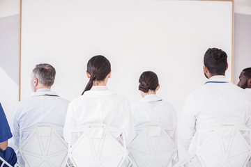 Physicians reclining on seat in hospital office