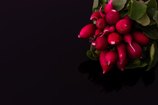 Close up of fresh turnips on a black background