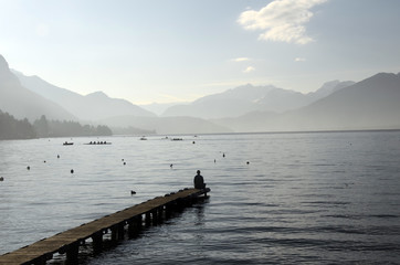 Man sitting on pontoon lake annecy