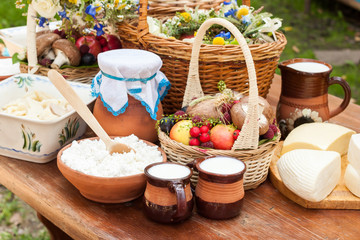 Dairy products on wooden table. Cheese and milk on the table in an earthenware dish. Rural food. Food background.