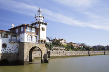 Obraz premium Arriluce lighthouse in the coast of Getxo, Biscay, Spain. Long exposure shot, on a sunny day.