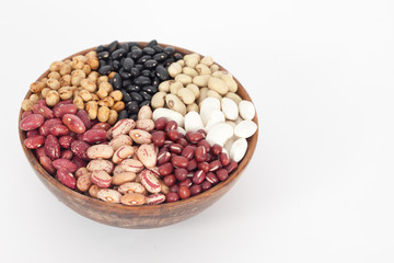 Assortment of different types of beans - red beans, chickpeas, peas in wooden bowl
