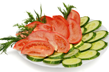 diced cucumbers and tomatoes on a plate isolated on white with shadow