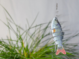 Fishing tackle and fishing lures on the background of the wooden planks.