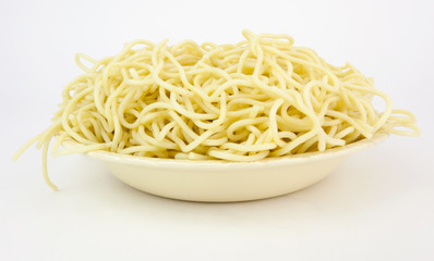 Spaghetti pasta in a white bowl. No sauce. White background.