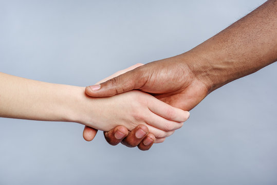 Friendly handshake by people of different ethnicity