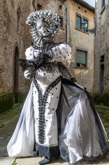 Fototapeta na wymiar Superb carnival mask on parade in the Tuscan village of Castiglion Fibocchi, Arezzo, Tuscany, Italy
