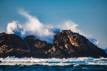 Wave splashing against a rock in the sea