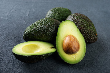 Fresh avocado on dark background. Vegetarian  food concept. Selective focus - obrazy, fototapety, plakaty
