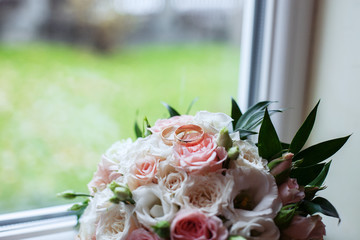 Wedding bouquet and rings. The concept of marriage and love.