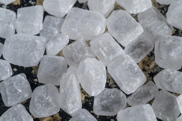 crystalline sugar (candy)  white,  on black background.