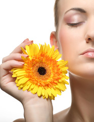 Beautiful young woman with gerber flower