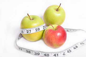 Apples on a white background with measuring tape. Healthy and proper nutrition with vitamins