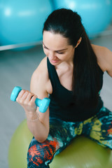 Fitness woman standing with dumbbells back sport