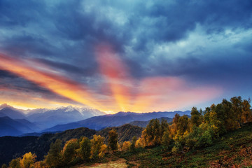 Sunset over snow-capped mountain peaks.