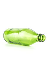 Glass green bottle lying down isolated on white background