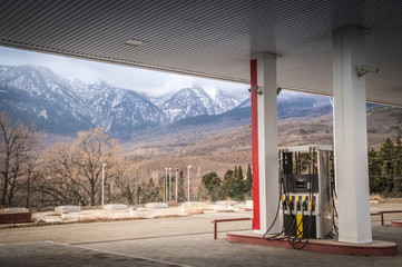 Gasoline refueling car with views of the snow mountains
