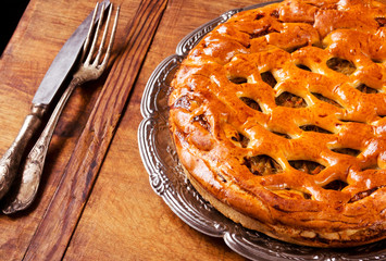 Homemade cabbage pie on wooden table