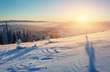 Fantastic winter landscape in the mountains. Magical sunset in a