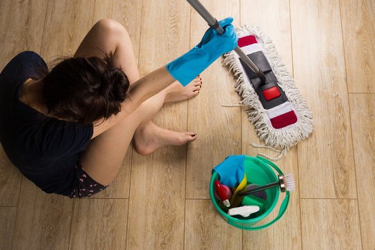
Girl tired of cleaning the house, washing the floors sits on poluv depression