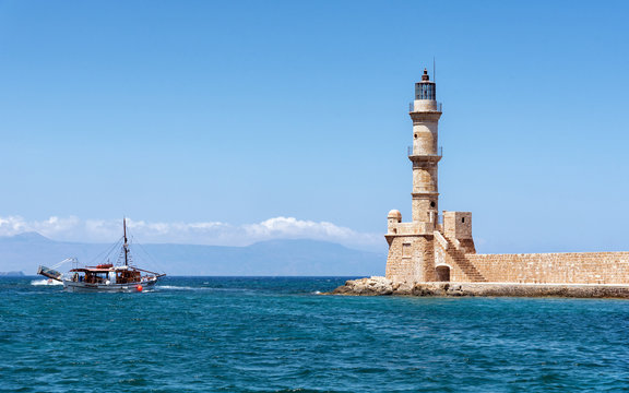 Boat and lighthouse of Chania town on Crete island, Greece