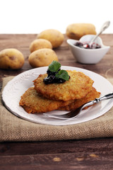Potato pancake with cow berry sauce, selective focus