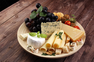 Cheese platter with different cheese and grapes